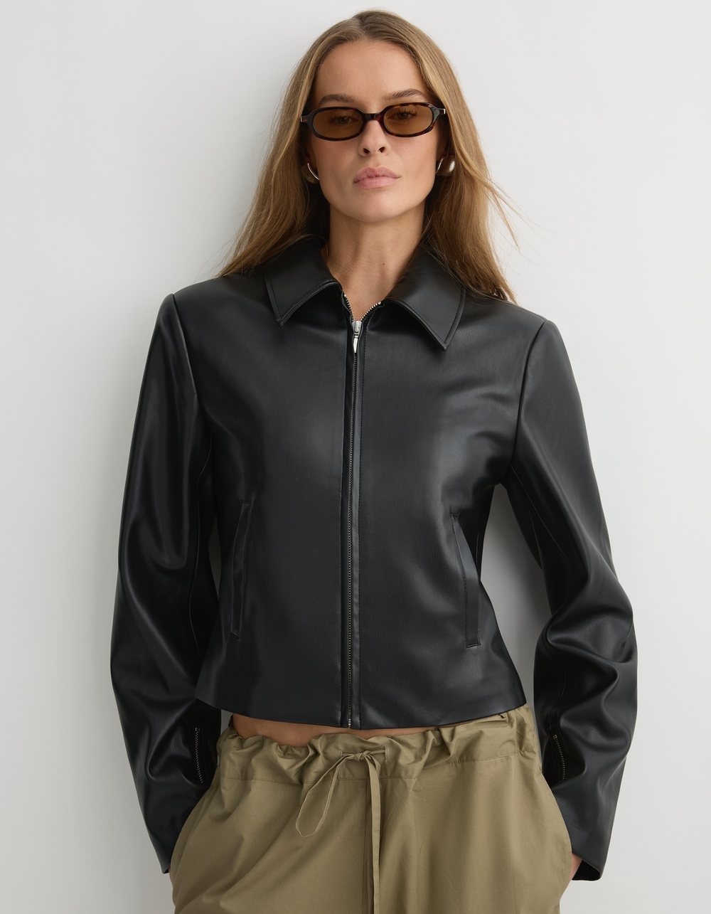 The Giselle Jacket in black, a cropped jacket with a full length silver zip.